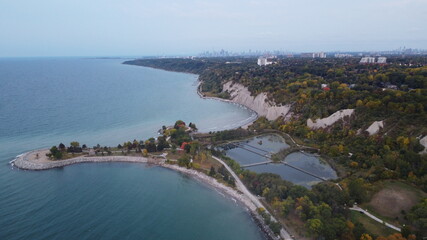 Aerial Panoramic Landscape Image of a Coastline in Toronto with beautiful park and skyline and nature view during fall with autumn colours during dawn