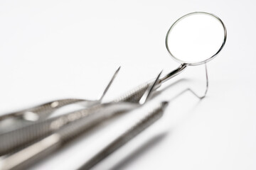 Basic dentist tools on white background.