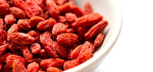 白バックと左側に白いお皿とクコの実　右側にコピースペース
