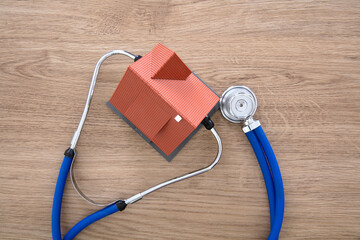 Looking down a house model with a stethoscope on the table