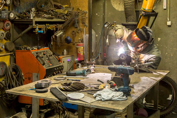 Welder solders copper car radiator with gas torch