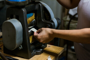 Jewelry maker woman working in professional jewelry workshop at her workbench.