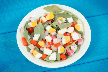 Fresh salad in glass bowl on boards, dieting and healthy nutrition concept