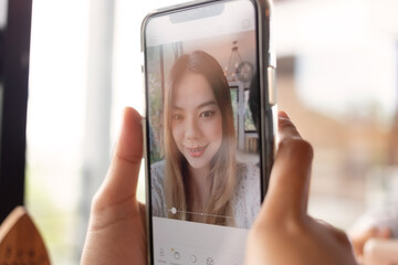 Portrait of asian girl selfie with smartphone. Beautiful asian women are take a photo on smartphone.