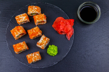 Sushi rolls Philadelphia on a black slate. Top view