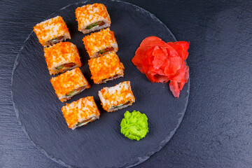 Sushi rolls Philadelphia on a black slate. Top view