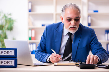 Old face injured employee sitting in the office