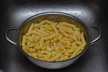 assorted pasta in an aluminum colander