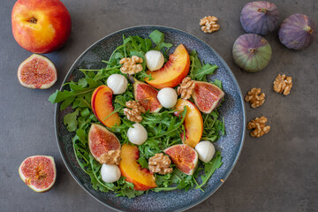 healthy arugula salad with mozzarella cheese and figs 