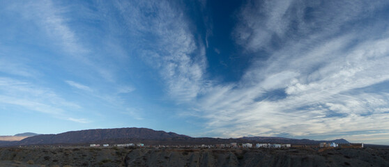 Culture and religion. Panorama view of an aboriginal cemetery very high in the mountains under a dramatic blue sky with clouds.The graveyard and tombs in the mountain summit very early at sunrise.