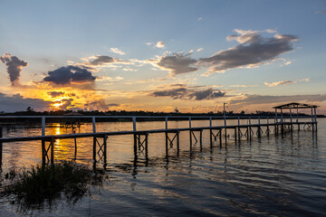 Fototapeta na wymiar pier on the edge of a lake with sunset background in Brazil