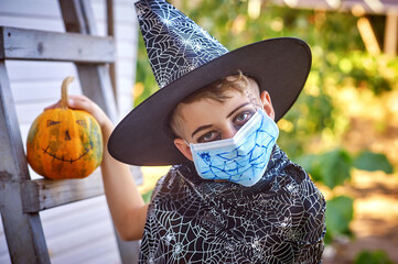 Portrait of a boy in a carnival costume for Halloween. Children wearing masks to protect against...
