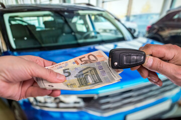 new car. buy or rent. hand holding euro banknotes