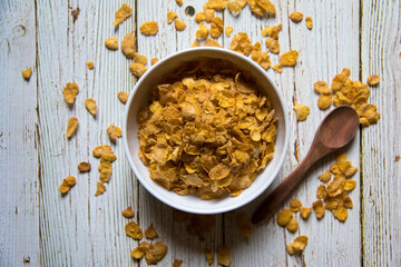Top view of cornflakes in a bowl on a background with use of selective focus.