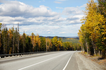Fototapeta premium Beautiful asphalt roadway to lake Baikal on a Sunny autumn day, Russia.
