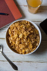 Close up view from top of a bowl of corn flakes with use of selective focus.