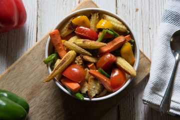 Close up top view of  vegetables and meat saute in a bowl on a background.