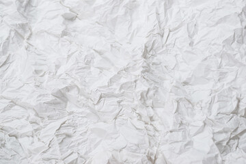 Crumpled white paper background.