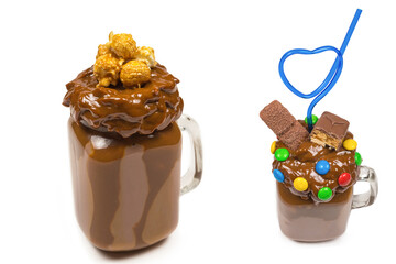 Chocolate milkshake with whipped cream, cookies, waffles, served in glass mason jar. 