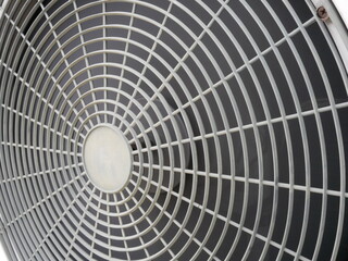 closeup of air conditioner compressor outside building.