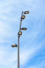 Fototapeta na wymiar modern street lamp with LED lamps on blue sky background