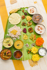 Traditional Onam sadhya, boiled rice, served for Kerala Indian festival  with curries Sambar, Rasam, Pulisseri, Avial, Thoran, Papadum, Payasam, Banana, Yogurt or Buttermilk, chips
