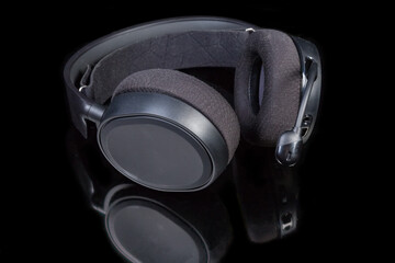 Black headset with full size headphones on a dark surface