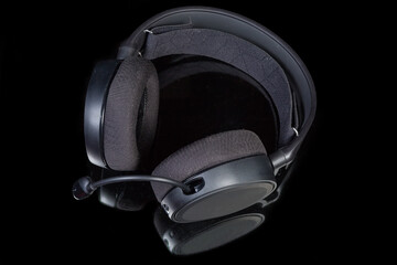 Fototapeta na wymiar Top view of headset with circumaural earpads on dark surface