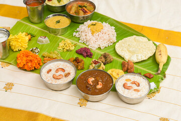 Traditional Onam sadhya, boiled rice, served for Kerala Indian festival  with curries Sambar, Rasam, Pulisseri, Avial, Thoran, Papadum, Payasam, Banana, Yogurt or Buttermilk, chips