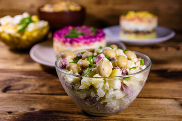 Set of festive mayonnaise salads on wooden table