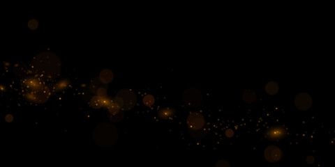 Golden particles, sparkling glitter dust on dark background.	