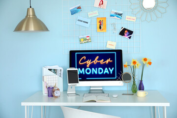 Text CYBER MONDAY on screen of monitor computer on table in room