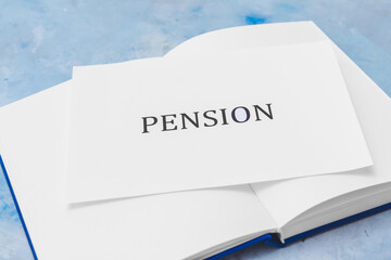 Book with word PENSION on color background, closeup