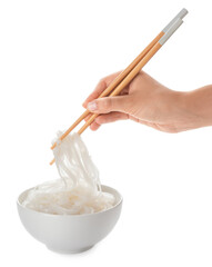 Woman eating tasty rice noodles on white background