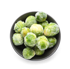 Bowl with frozen Brussels sprouts on white background