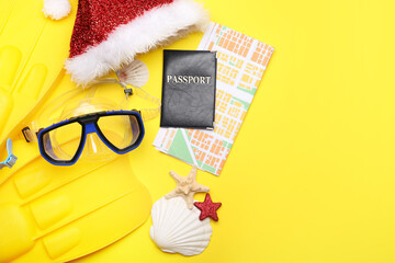 Composition with Santa Claus hat, map and passport on color background