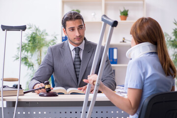 Young injured woman and male lawyer in the courtroom
