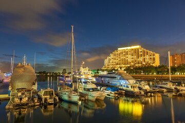 yacht and motor boat at harbor moored at jetty under sunset in Hong Kong