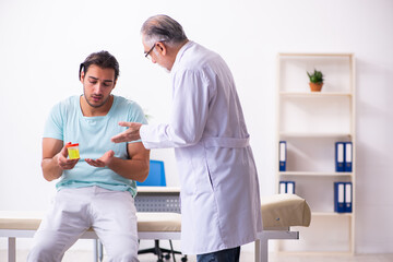 Young male patient visiting experienced doctor