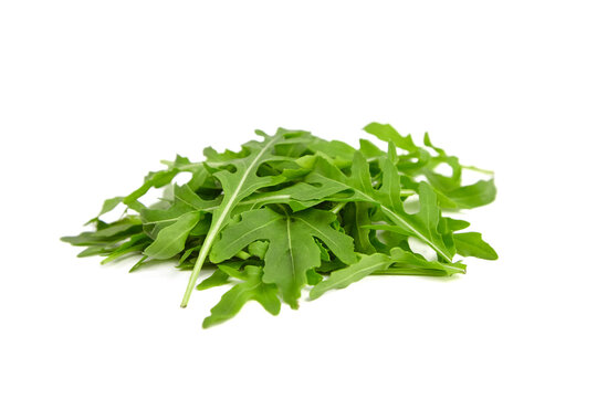 Fresh organic arugula leaves heap isolated on white background