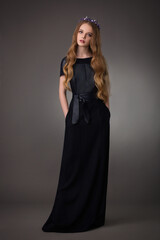 Fototapeta premium beautiful teen blonde girl with exquisite makeup in a stylish black dress