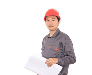 In front of white background a worker holding engineering drawings wearing a red hard hat looking at the camera