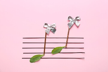 Music notes made of different materials on color background