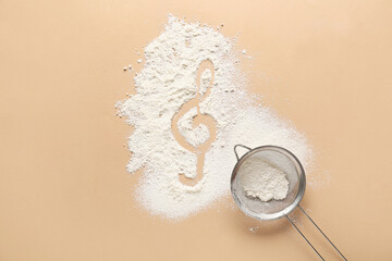 Violin clef drawn on flour against color background