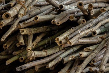 Bunch of bamboo stems piled up together in a handicraft shop