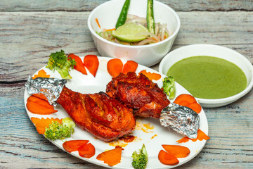 Chicken Tangri - Chicken leg piece is marinated in curd, ginger garlic, and spices. It can be served with green chutney