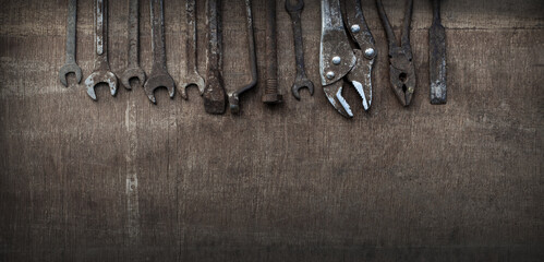 Old tools on wooden background. Old tools because they have been used long and hard. Banner background.