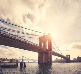 Wandaufkleber Vintage toned picture of Brooklyn Bridge against the sun, New York. © MaciejBledowski