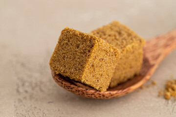 Close up of  two panela blocks on wodden spoon.