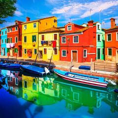 Fototapeta na wymiar Burano island canal, colorful houses and boats in the Venice lagoon. Italy